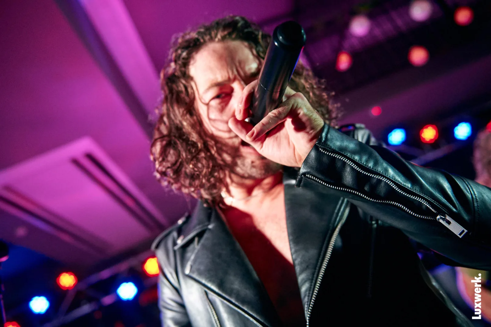 Singer from an INXS tribute band singing into the camera