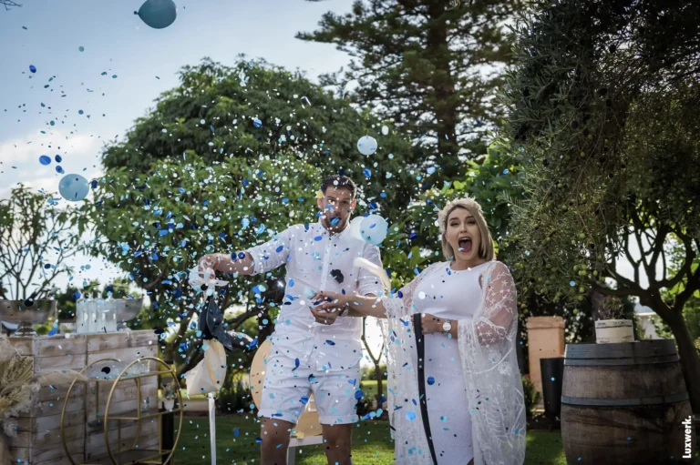 Couple popping a Gender Reveal Ballon